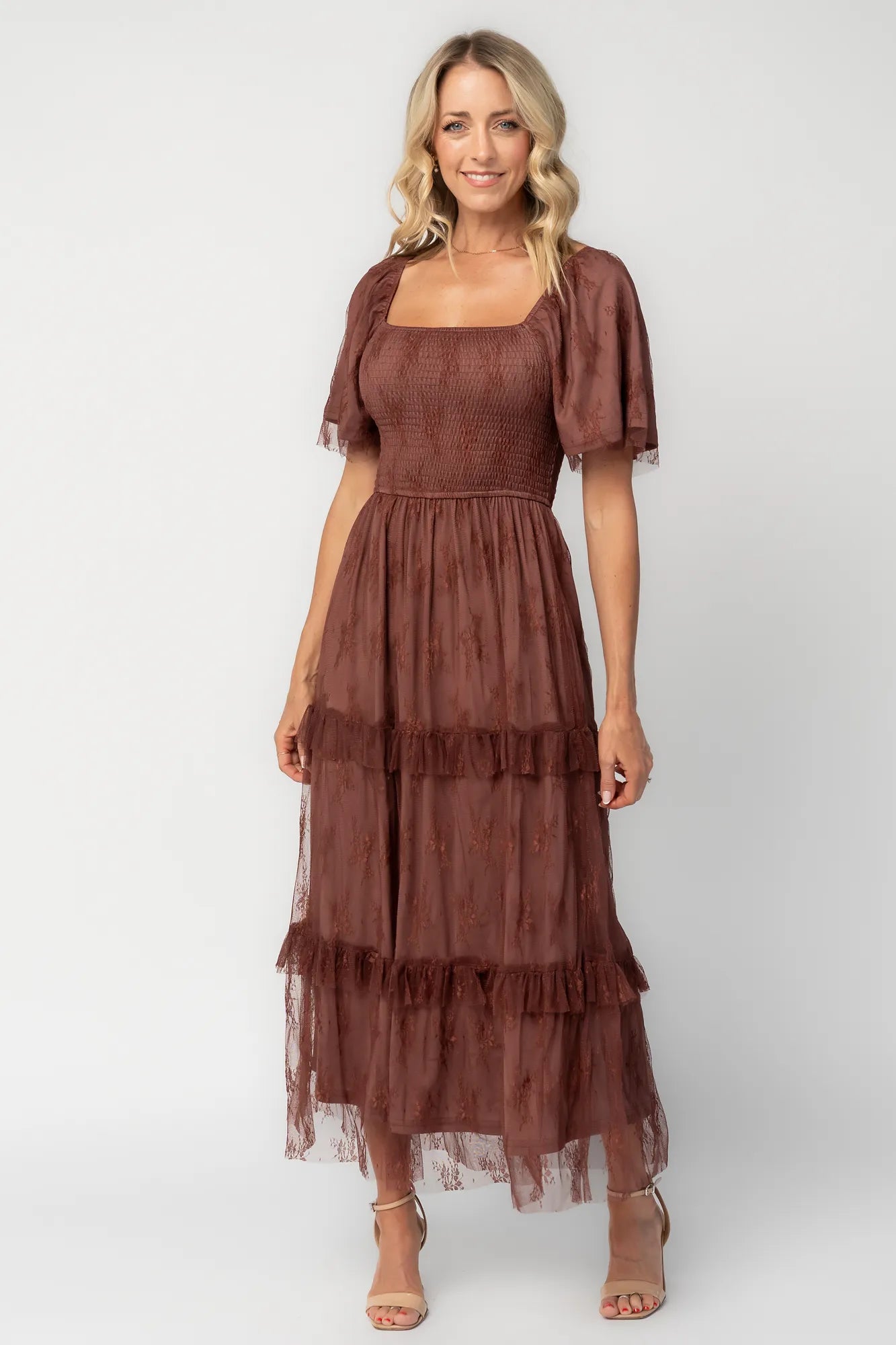 Model wearing a mahogany lace maxi dress with a square neckline, short sleeves, and a smocked bodice.