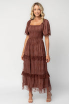Model wearing a mahogany lace maxi dress with a square neckline, short sleeves, and a smocked bodice.