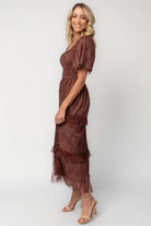 Model wearing a mahogany lace maxi dress with a square neckline, short sleeves, and a smocked bodice.