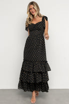 Back view showing smocked back bodice and adjustable self-tie straps on the Kassia Maxi Dress; lined bodice excludes straps.