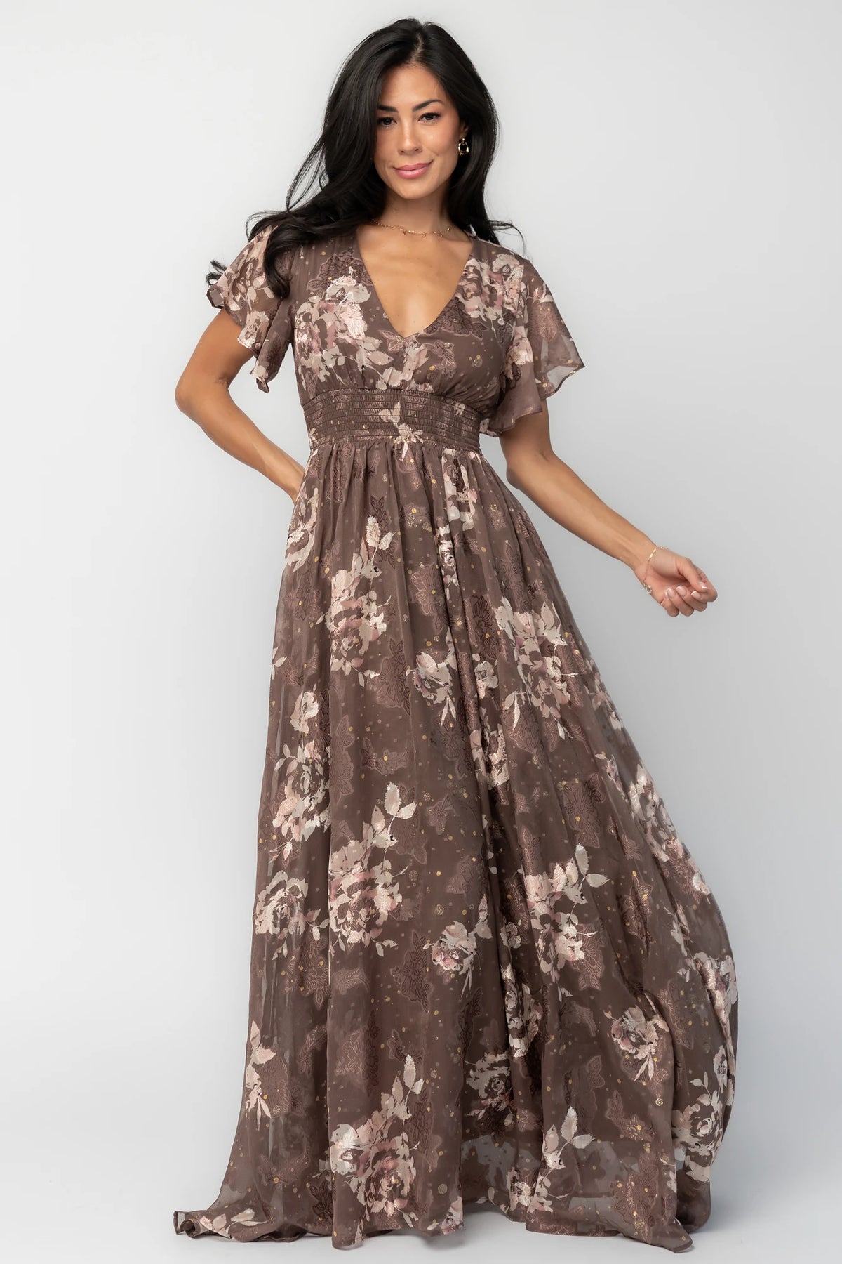 Mocha metallic floral chiffon maxi dress with a V-neckline, flutter sleeves, smocked waist, and flowing full-length skirt.