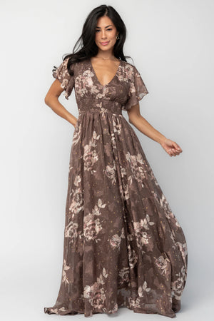 Mocha metallic floral chiffon maxi dress with a V-neckline, flutter sleeves, smocked waist, and flowing full-length skirt.