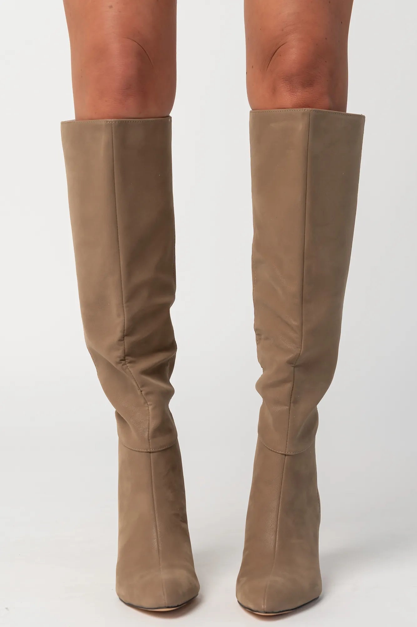 Pair of mocha knee-high boots featuring a pointed toe, sleek fitted shaft, and sculpted kitten heel. The streamlined silhouette and smooth finish create an elegant, versatile look that pairs effortlessly with dresses, skirts, and tailored outfits.