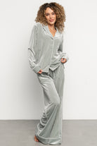 Back view of Klara pajama set in sage showing high-low hem and relaxed wide-leg silhouette on model.