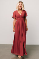 Studio flat-lay of the terracotta Ramona maxi dress showing silhouette, left leg slit and delicate chiffon fabric.