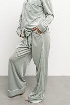 Close-up of ribbed velvet fabric texture in light sage, highlighting soft stretch and subtle vertical rib pattern.