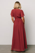 Detail image of short flutter sleeves and V-neckline on the terracotta Ramona chiffon maxi dress.