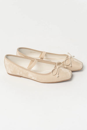Pair of taupe velvet Mary Jane ballet flats featuring a square toe, delicate bow detail, and elastic strap across the foot. The classic flat silhouette offers a timeless, feminine look for everyday wear.