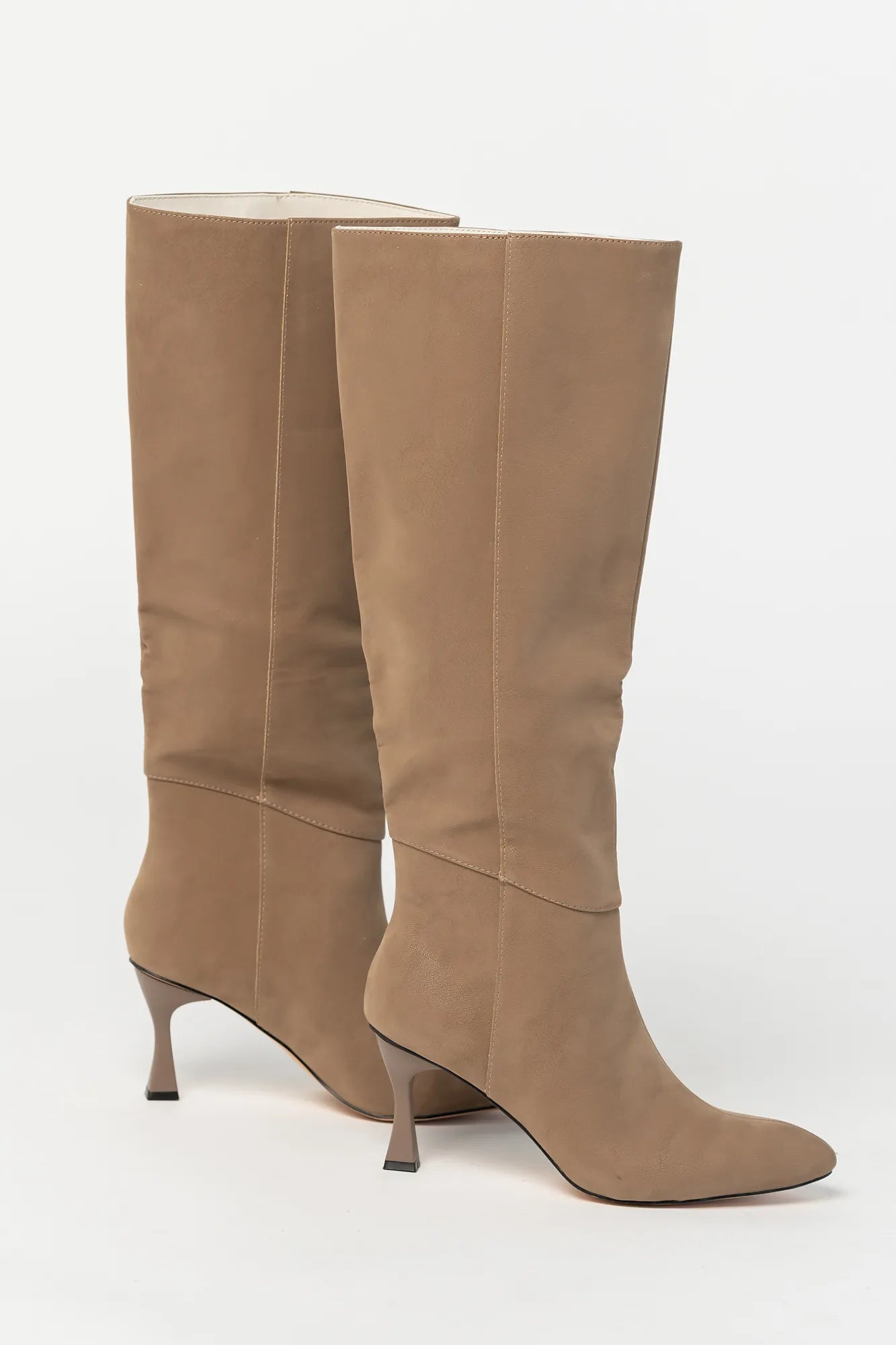 Pair of mocha knee-high boots featuring a pointed toe, sleek fitted shaft, and sculpted kitten heel. The streamlined silhouette and smooth finish create an elegant, versatile look that pairs effortlessly with dresses, skirts, and tailored outfits.