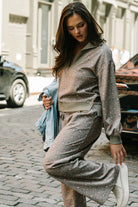 Model wearing the Diana Lounge Set in Olive Floral featuring a matching long-sleeve half-zip top and wide-leg pants.