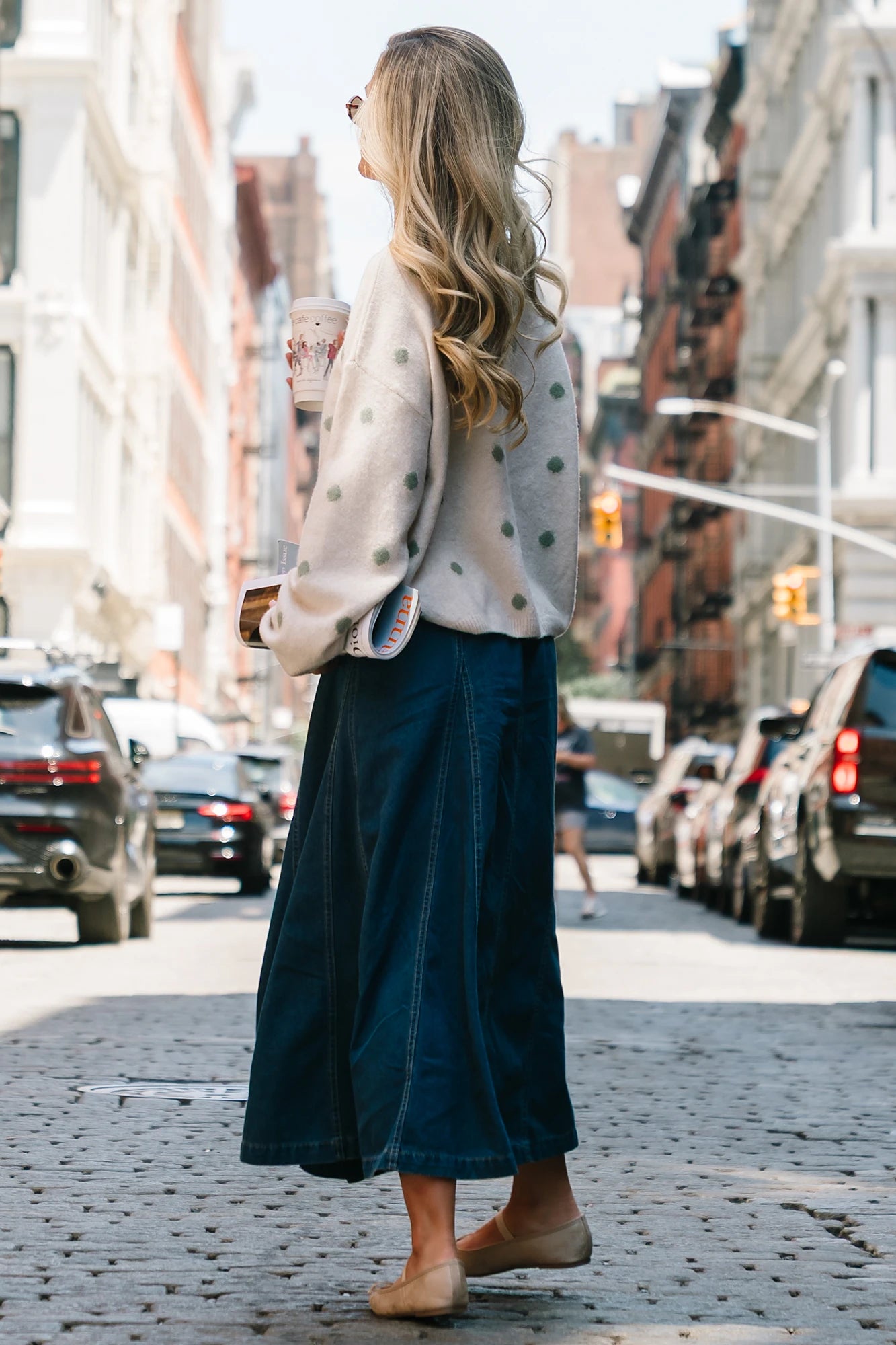 Model wearing the Cece Button-Down Denim Skirt in a dark wash featuring a button-front placket, elastic back waist, and a classic knee-length silhouette.