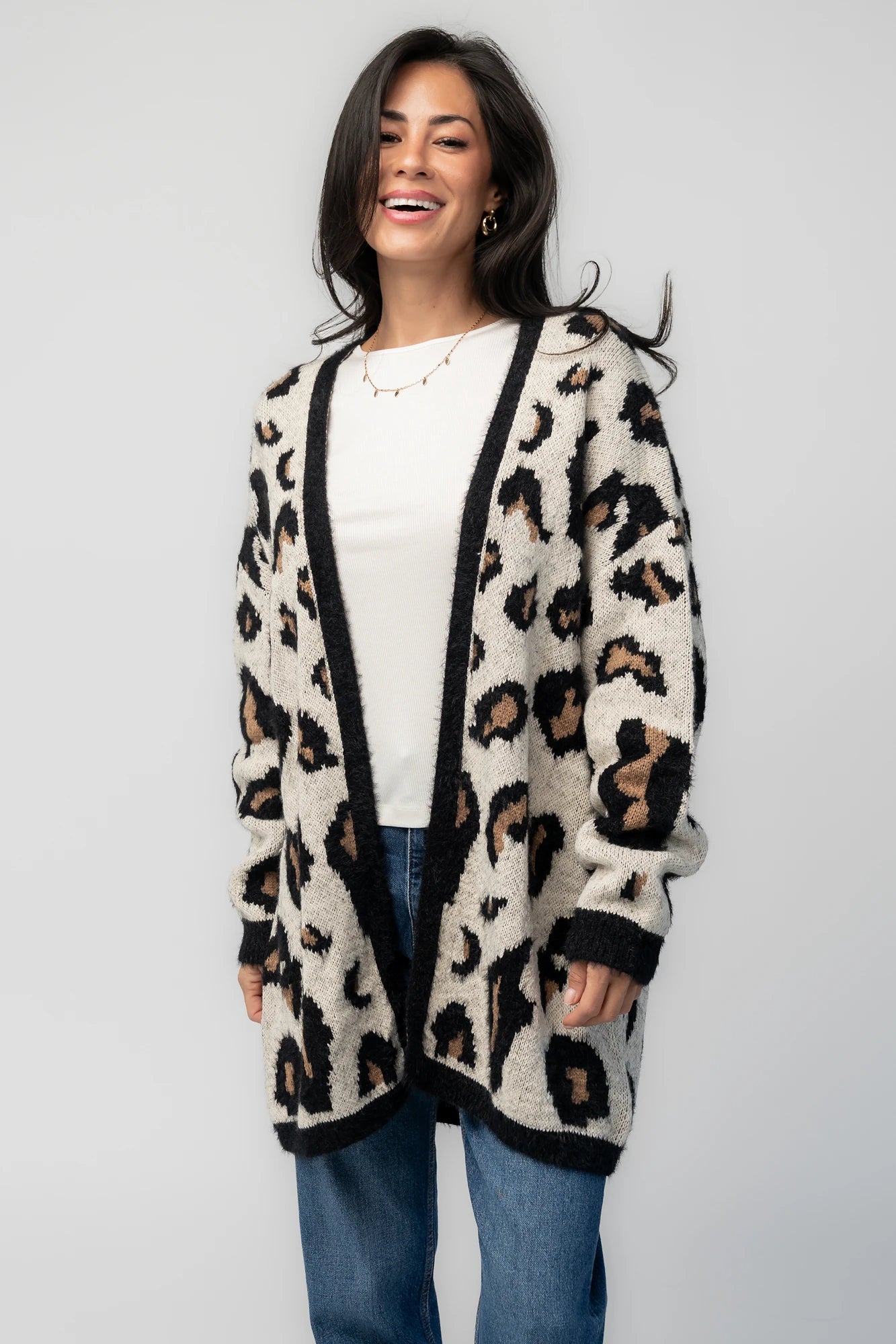 Model wearing the Jeter Open Cardigan in Leopard Print featuring a neutral knit with black and camel leopard print.