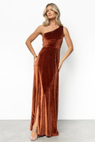 Full-length studio shot of bronze Tatiana velvet dress showing one-shoulder tank, right-side slit to mid-thigh, and smooth velvet texture.