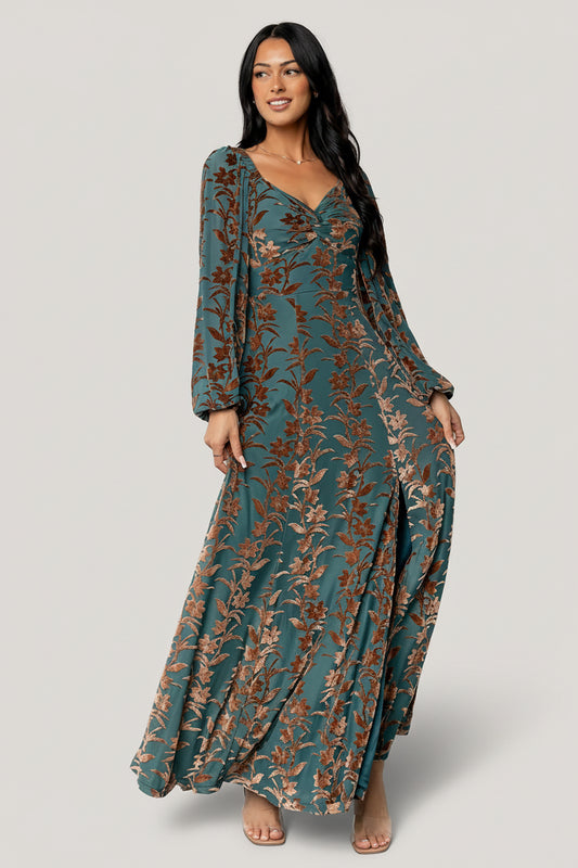 Model wearing Aurora Velvet Maxi Dress in Jade & Bronze Floral, front view showing sweetheart neckline and maxi skirt.