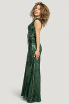 Side profile of Alessia green gown showing fitted bodice, mermaid flare at the skirt hem and graceful floor-length drape.