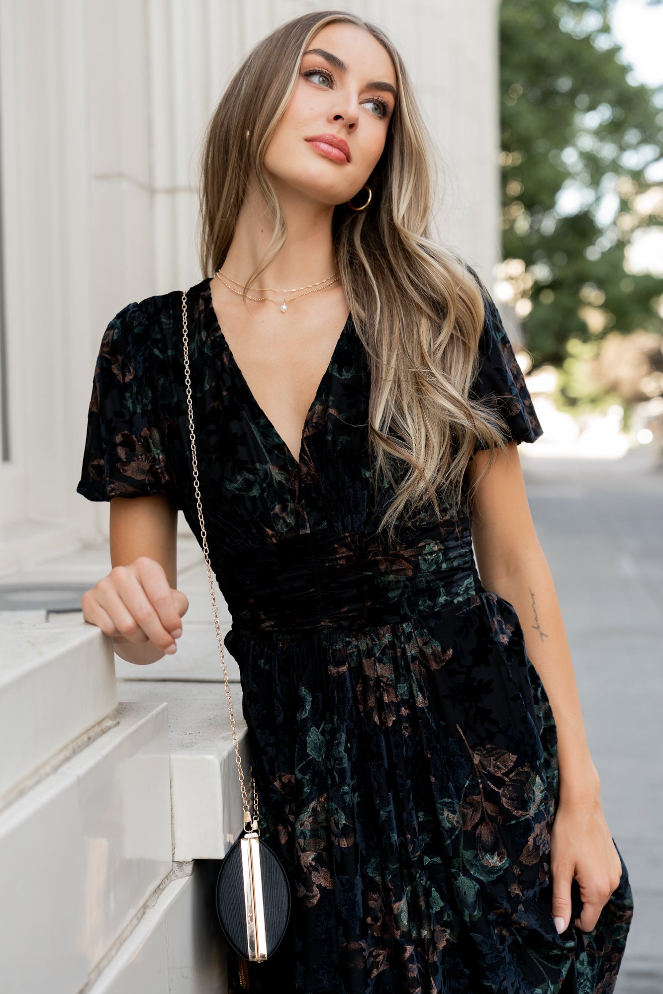 Model walking in Leslie Velvet Maxi Dress; shows movement of maxi skirt, short puff sleeves, and overall drape of the garment.
