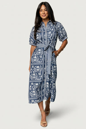 Front view of Karla midi dress in deep slate with off-white floral print, collared neckline, button-down front, and adjustable waist sash.