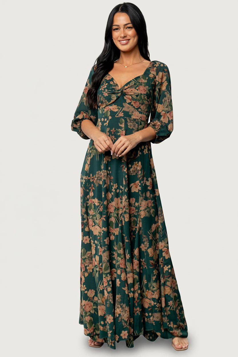 Front view of green maxi dress with copper and yellow floral print, V-neck twist knot, smocked back and flowy godet hem.