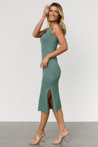 Side view of Rue Ribbed Midi Dress in eucalyptus highlighting knee-high slit, tank straps, and the dress’s stretchy wide rib knit that contours the figure.