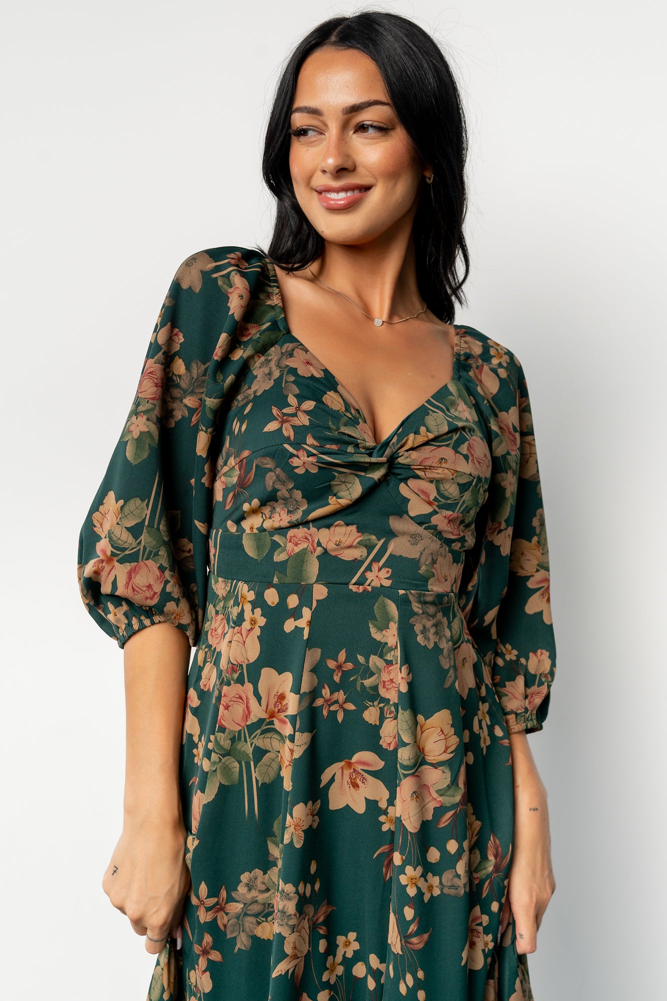 Side view of dress showing elastic shoulders, 1/2 sleeves with elastic cuffs, and the dress's flowing skirt movement.