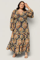 Close-up of navy floral chiffon fabric and ruffle detailing on the tiered maxi skirt; shows print scale and fabric texture.