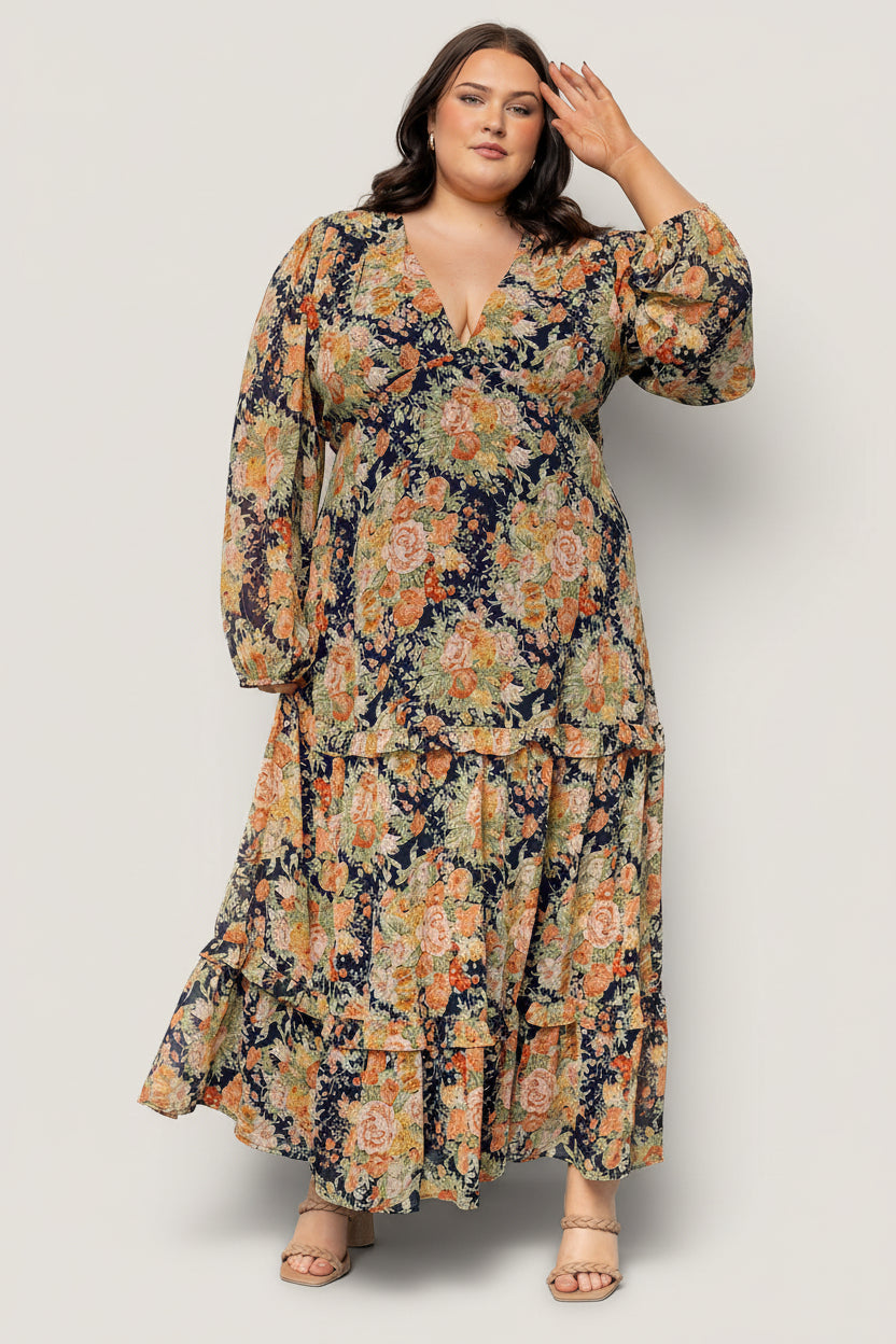 Close-up of navy floral chiffon fabric and ruffle detailing on the tiered maxi skirt; shows print scale and fabric texture.