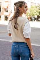 Model wearing the Taylor Top in a relaxed pose to show fit through the body and scale of the attached puff sleeves.