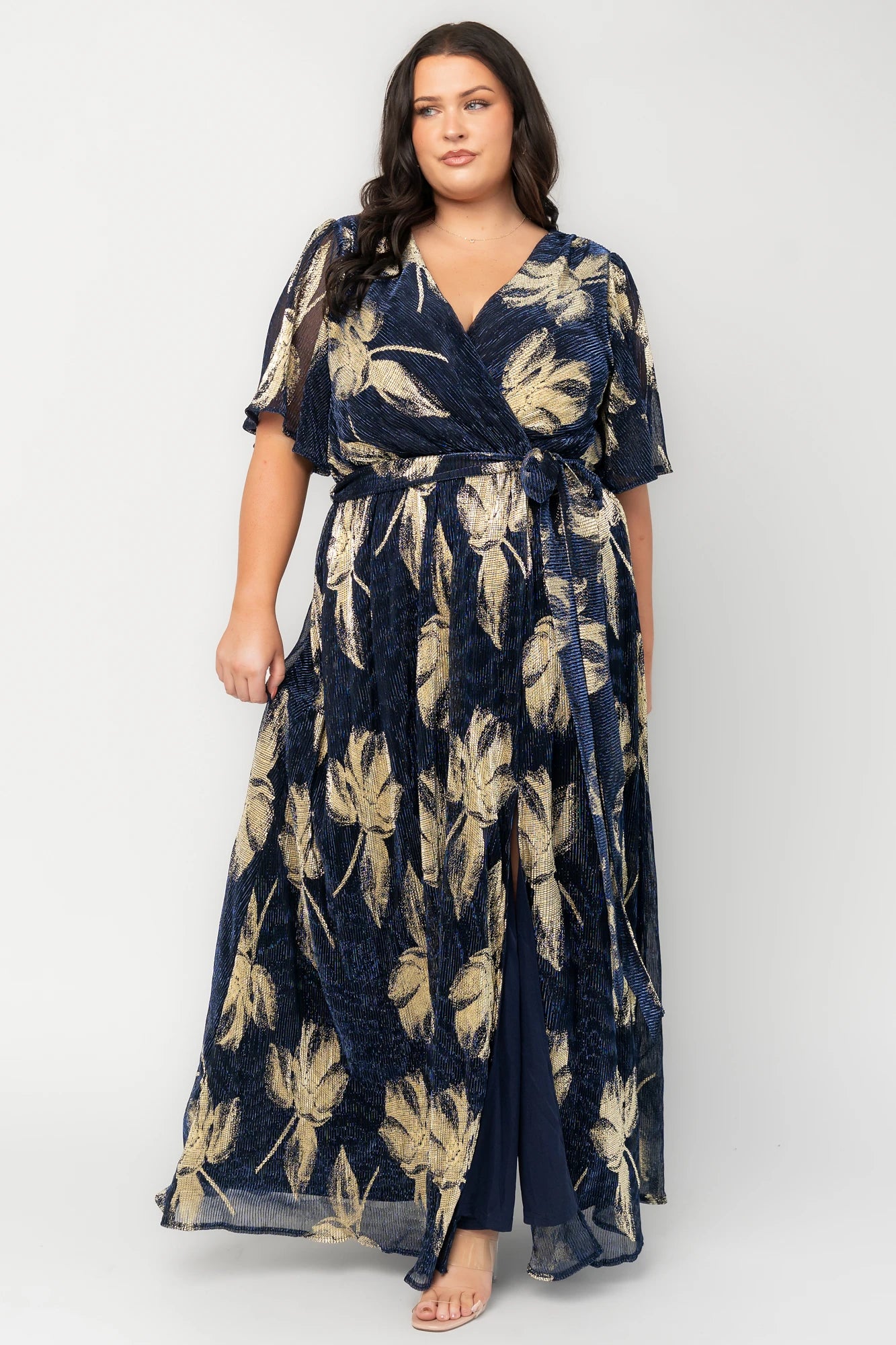 Rachel Maxi Dress in Navy + Gold with shimmer finish, surplice neckline, self-tie sash, long sleeves, and leg slit.