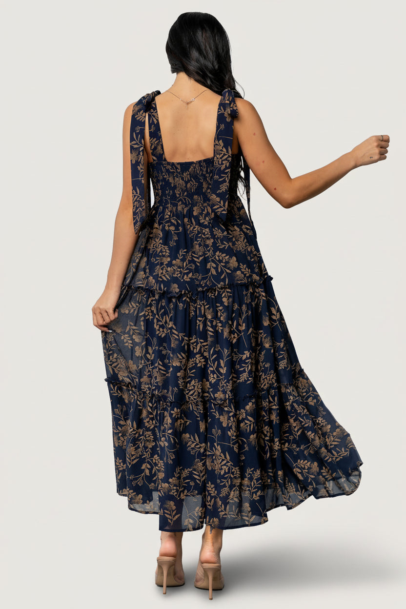 Fabric detail of the Anita Maxi Dress showing medium-weight chiffon overlay and the subtle gold floral pattern against a deep midnight background.