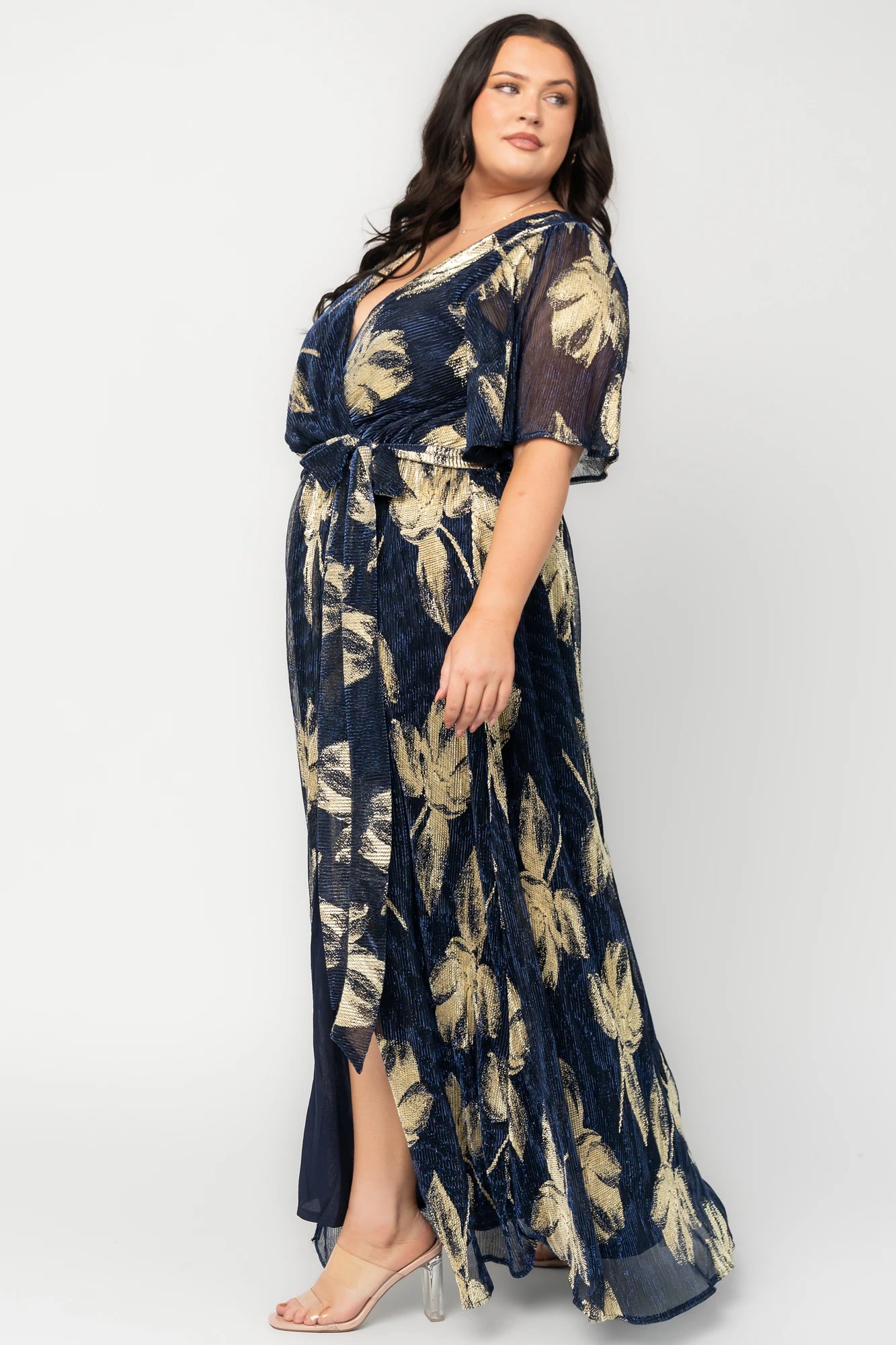 Rachel Maxi Dress in Navy + Gold with shimmer finish, surplice neckline, self-tie sash, long sleeves, and leg slit.
