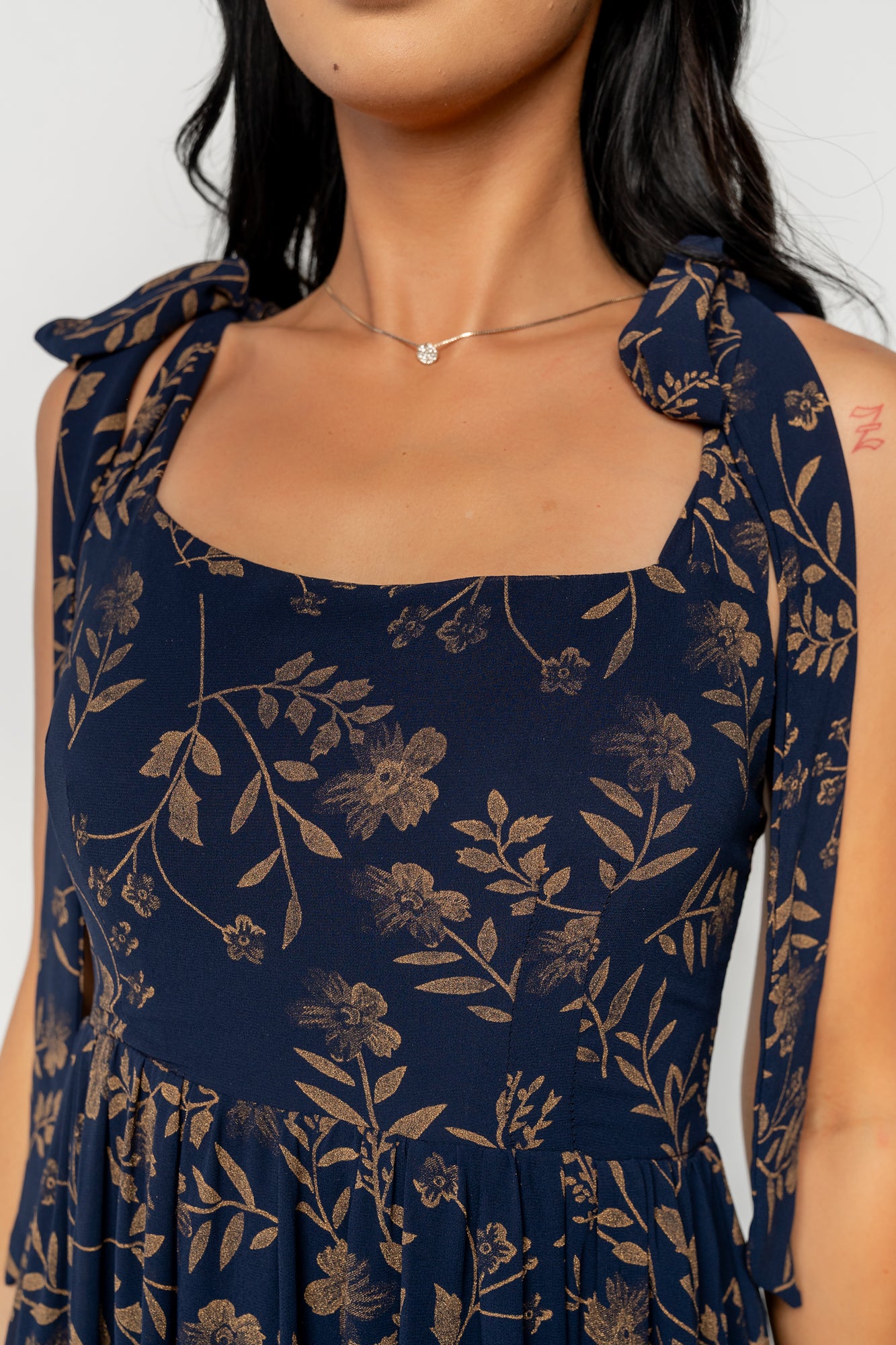 Side view of Anita Maxi Dress on model, showing adjustable self-tie straps, flowing chiffon tiers, and the elegant movement of the maxi skirt.