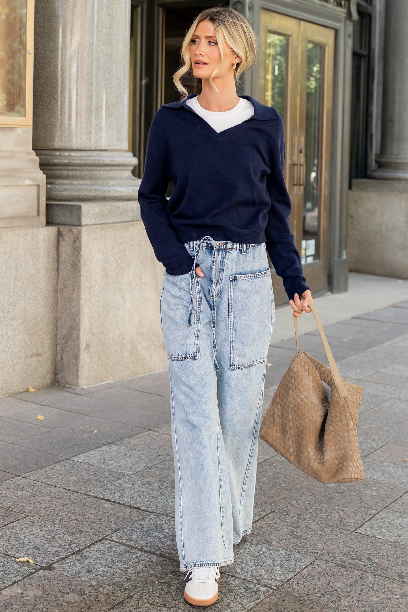 Close-up of navy Bodhi sweater knit showing soft viscose-blend texture, subtle stitch detail, and ribbed cuff construction.