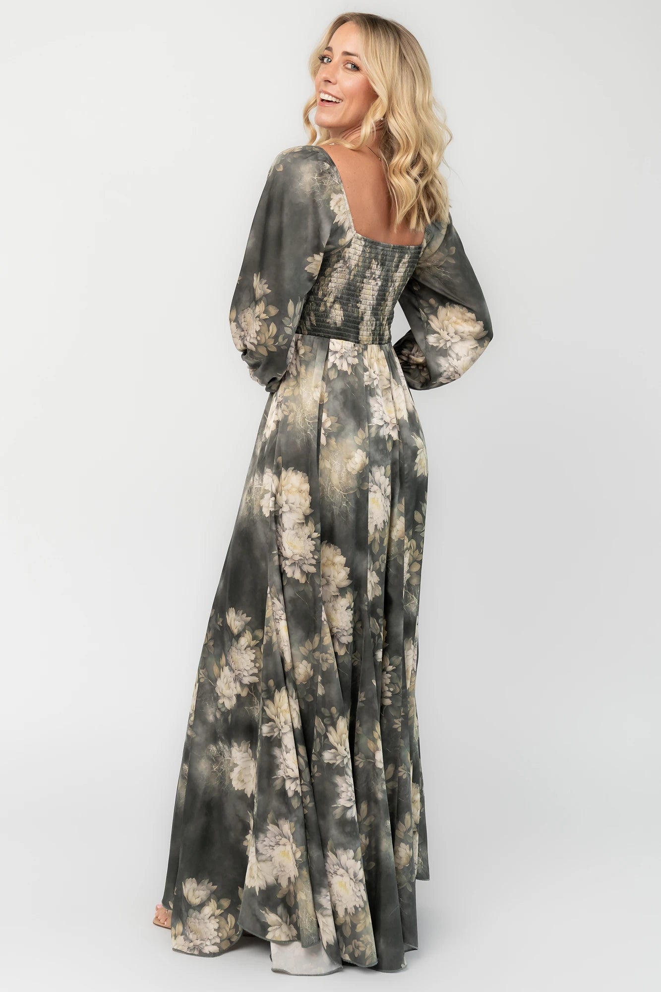 Dark sage floral maxi dress with a V-neck twist knot, half sleeves, smocked back waist, paneled empire waist, and flowing scalloped asymmetrical hem.