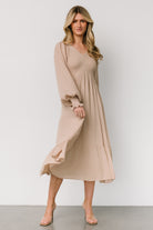 Close-up of beige dotted texture and smocked bodice detail, showing fabric texture and subtle raised dots.