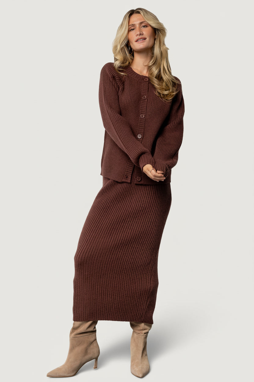 Close-up detail of the ribbed knit fabric and mahogany buttons on the Blair cardigan, showing fiber texture and button finish.