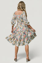 Detail shot of 3/4 length sleeve with elastic ruffle cuff on the multi floral smocked midi dress showing fabric drape.