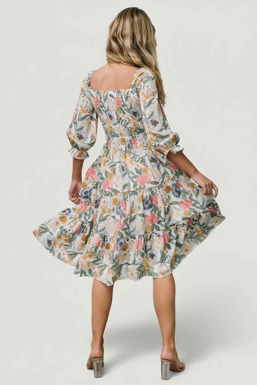 Detail shot of 3/4 length sleeve with elastic ruffle cuff on the multi floral smocked midi dress showing fabric drape.