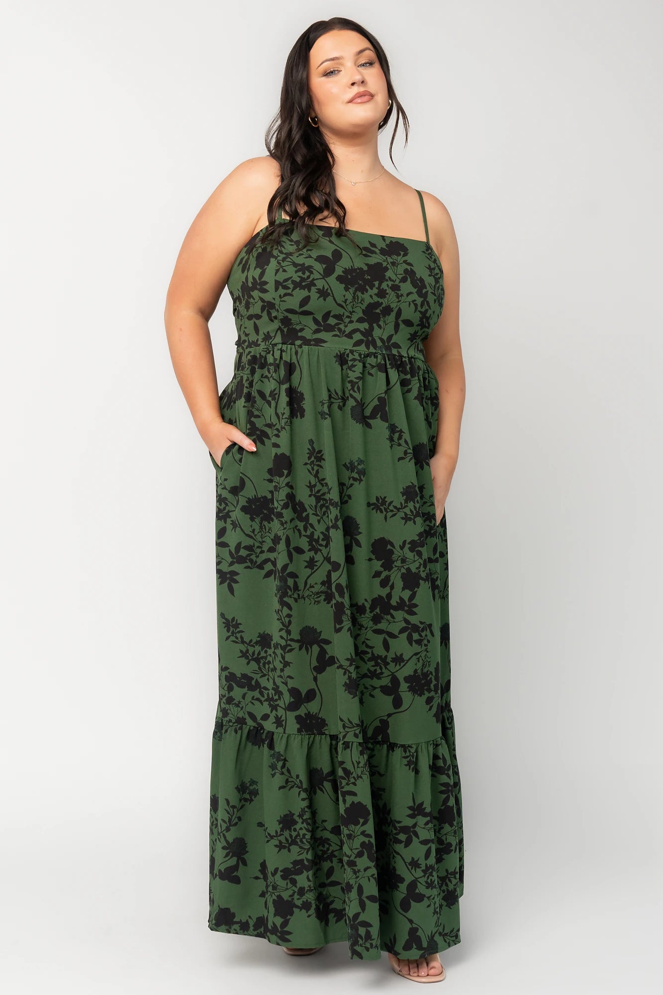 Rowan Tank Maxi Dress in Deep Olive with floral print, adjustable straps, smocked back, sash tie, and tiered skirt.