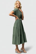 Styled outfit view of the Logan Button Up Dress in washed green, showing how the removable sash shapes the waist and the relaxed silhouette of the maxi dress.