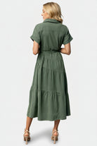Detail shot of cuffed short sleeves and fabric texture of the Logan Button Up Dress in washed green, noting the cotton-poly blend with no stretch.