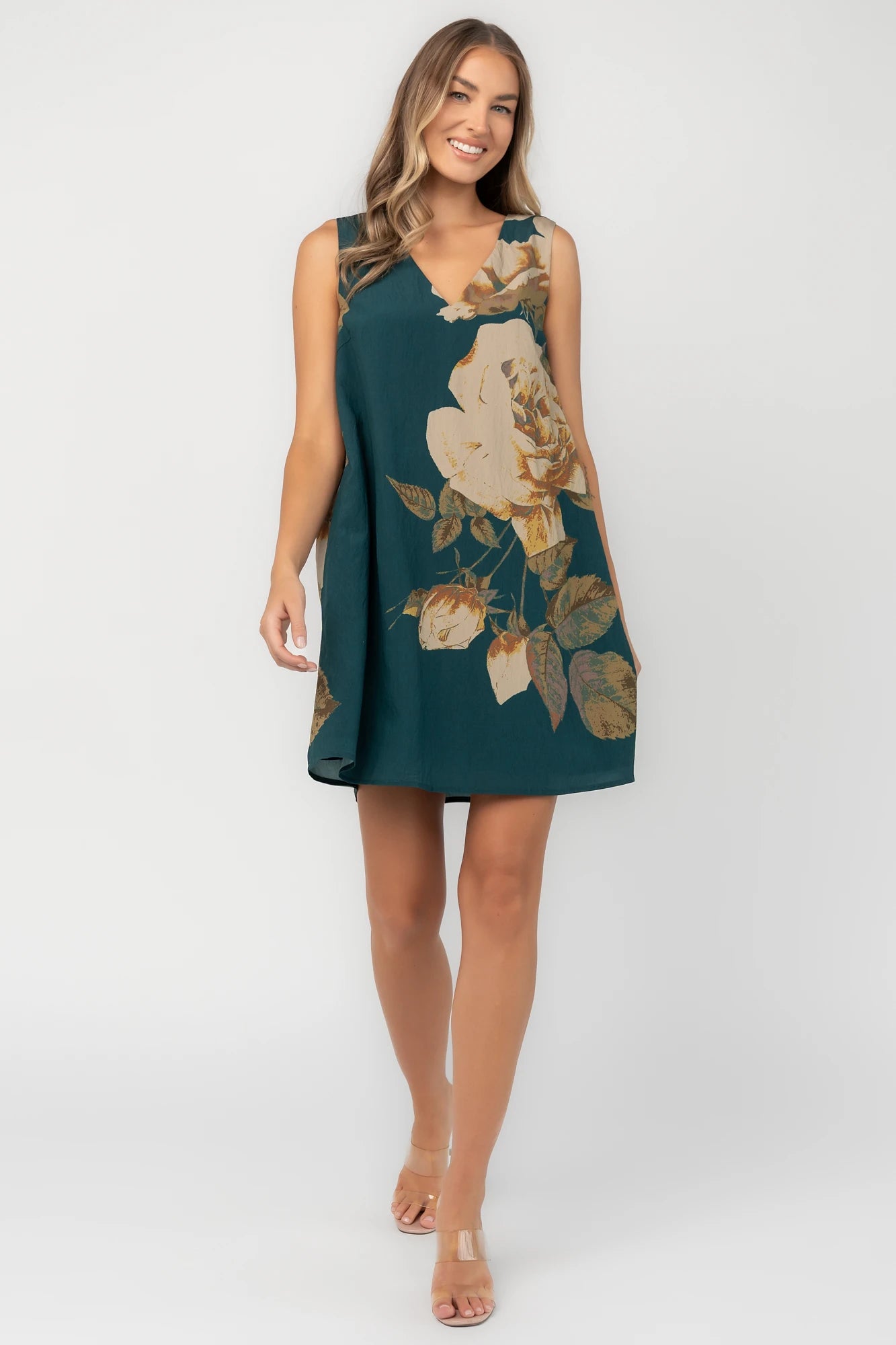 Deep topaz floral shift dress with a V-neckline, sleeveless silhouette, side pockets, and a relaxed above-the-knee fit.