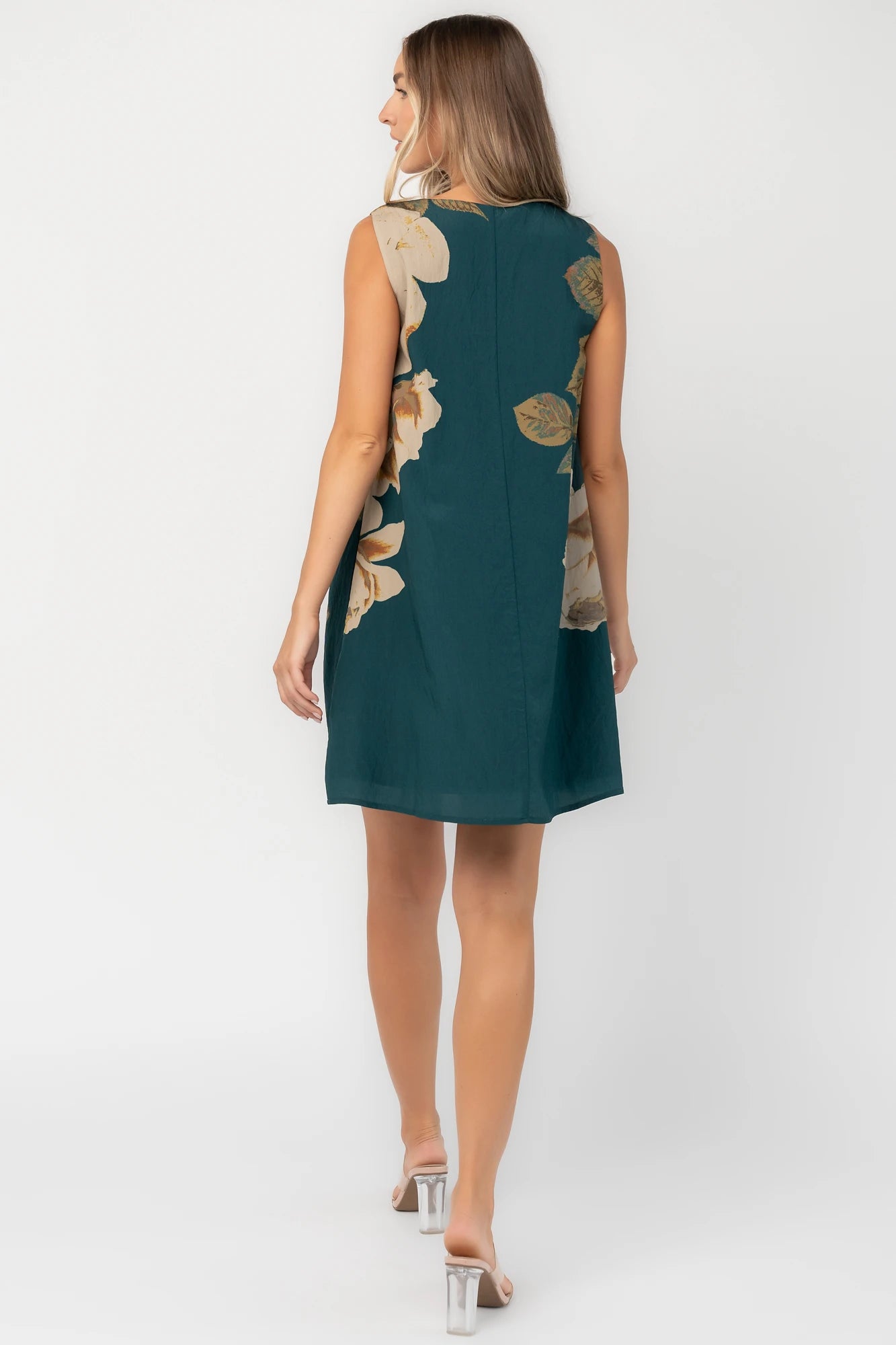 Deep topaz floral shift dress with a V-neckline, sleeveless silhouette, side pockets, and a relaxed above-the-knee fit.