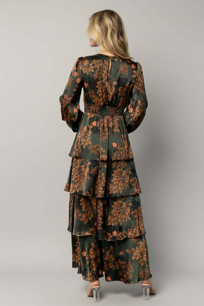 Back view of the Montrouge satin maxi dress displaying smocked back detail, unlined short sleeve, and tiered ruffle skirt silhouette on model.