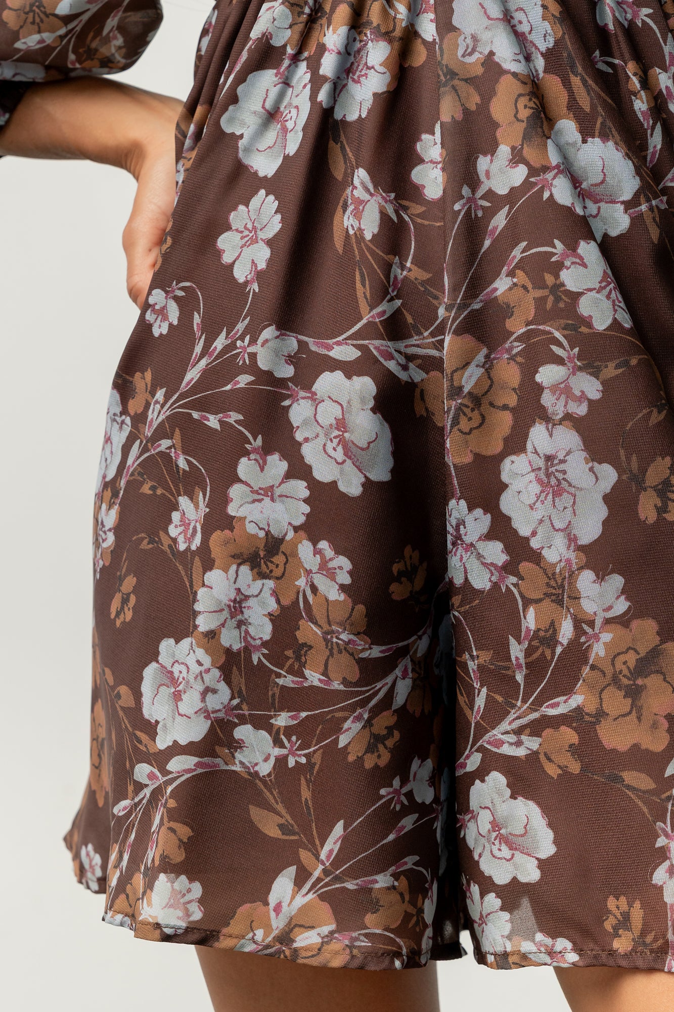 Close-up of floral print and chiffon texture on the Amalia romper with visible smocked back detail and delicate seam finishes.