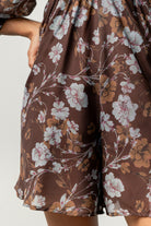 Close-up of floral print and chiffon texture on the Amalia romper with visible smocked back detail and delicate seam finishes.