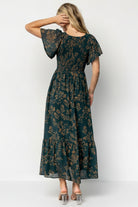 Back and movement shot of the Monica Smocked Maxi Dress in Deep Topaz, showing single-tier hem, fluid skirt motion, and overall silhouette.