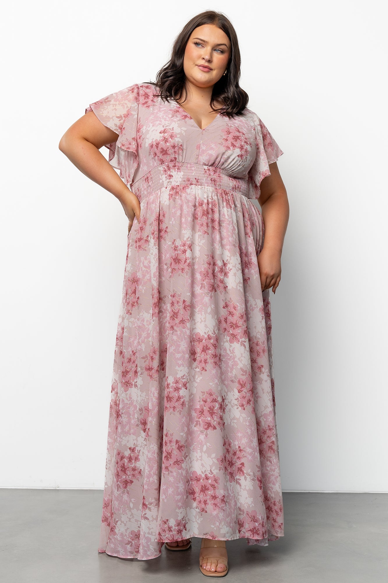 Close-up of Lynlee Metallic Maxi Dress fabric highlighting gold metallic threading over dusty pink floral chiffon, showing texture and delicate shimmer.