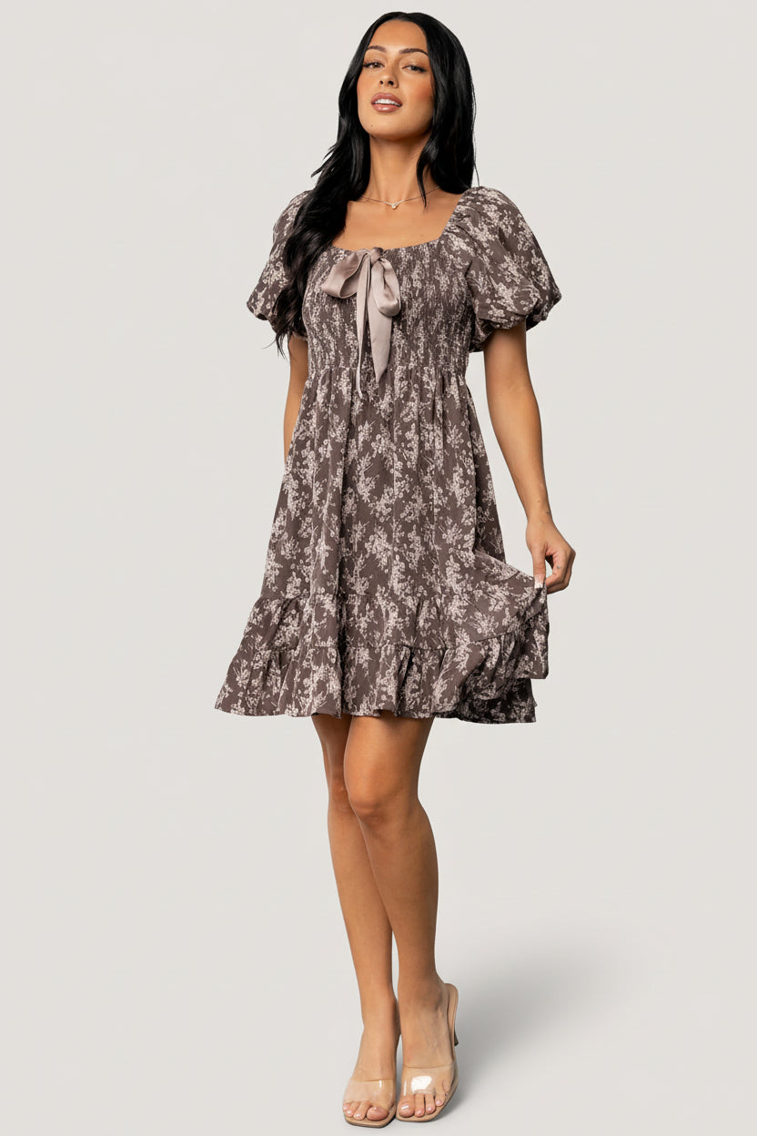 Side view of the short tiered skirt and hidden side pocket on the Anastasia Bow Short Dress, showing the lightweight drape and lining.