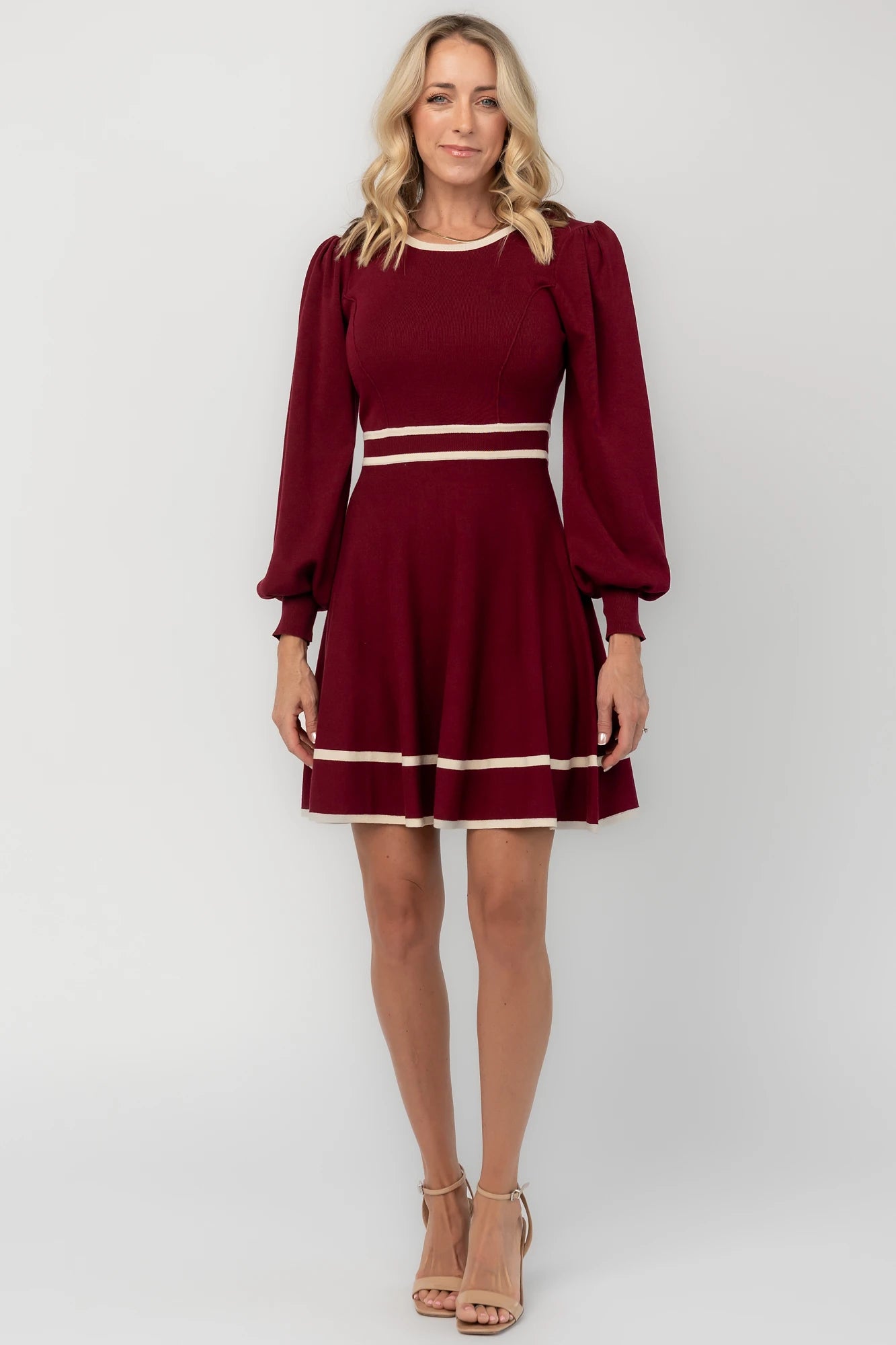 Rich wine knit mini dress with cream contrast trim, long balloon sleeves, a fitted waist, and a flared skirt.