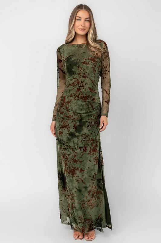 Green and rust floral mesh maxi dress with sheer long sleeves, boat neckline, and fitted silhouette.